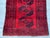 A moody, character-rich vintage Afghan Khal Mohammad Bokhara rug — five large dark-ground octagonal "Aina" (mirror) guls...