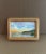 This petite landscape watercolor captures a tranquil coastal scene bathed in the soft glow of sunset. Framed in natural...
