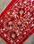 Hand-embroidered Suzani table runner from Uzbekistan — cream and ecru vine scrolls with pomegranate buds on a deep red...