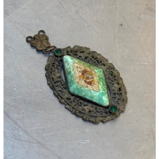 Early 20th-century Victorian style silver tone/micromosaic pendant with green stone detail. Some patina and visible age to...