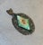 Early 20th-century Victorian style silver tone/micromosaic pendant with green stone detail. Some patina and visible age to...