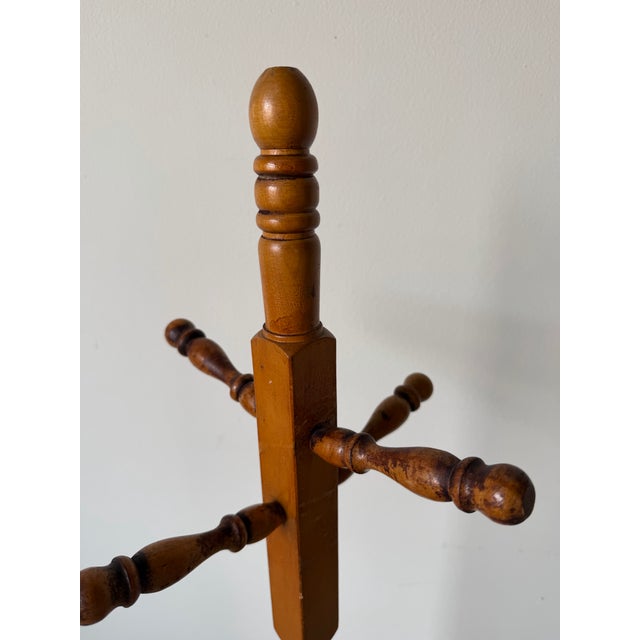 Classic 1970s vintage turned wood coat rack featuring a warm honey-toned finish and beautifully carved spindle details....