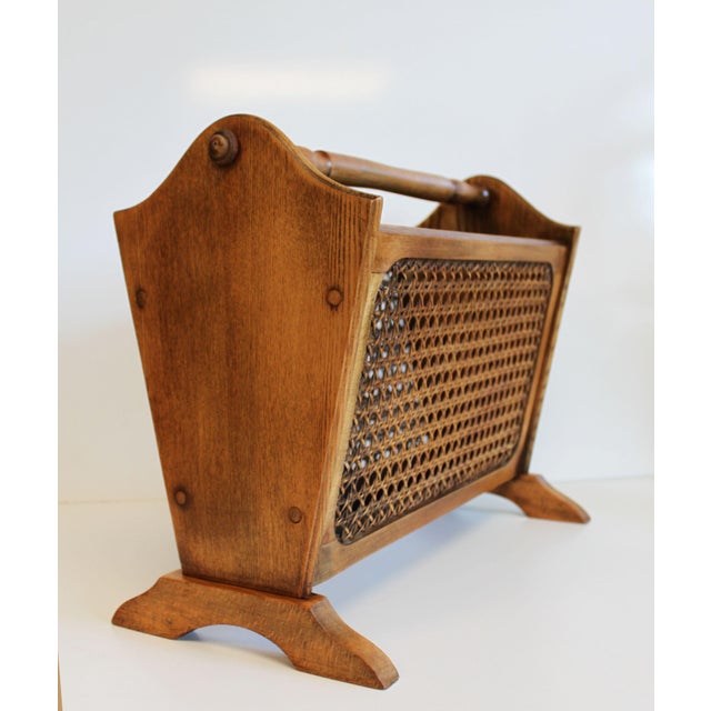 Vintage wooden magazine rack with cane panels. Practical thanks to its central handle, it's easy to move from one room to...