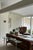 Sculptural vintage console table featuring a freeform glass top resting on a sweeping curved lucite base. The transparent...