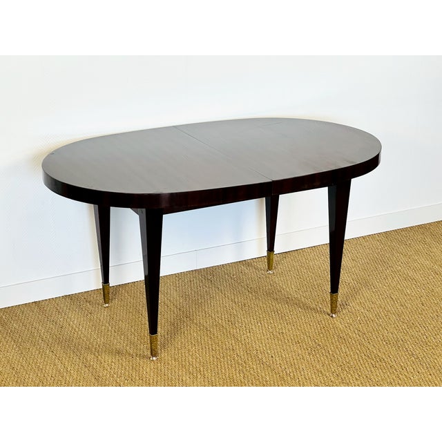 An elegant Art Deco dining table crafted from rosewood veneer with a refined, regular vertical grain. The tabletop...