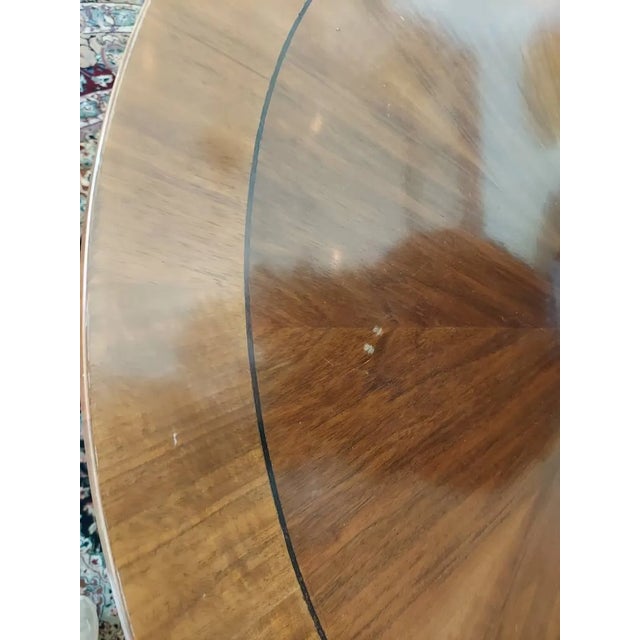 A striking statement piece designed to anchor an entryway or grand foyer. This 43-inch round center table features a...
