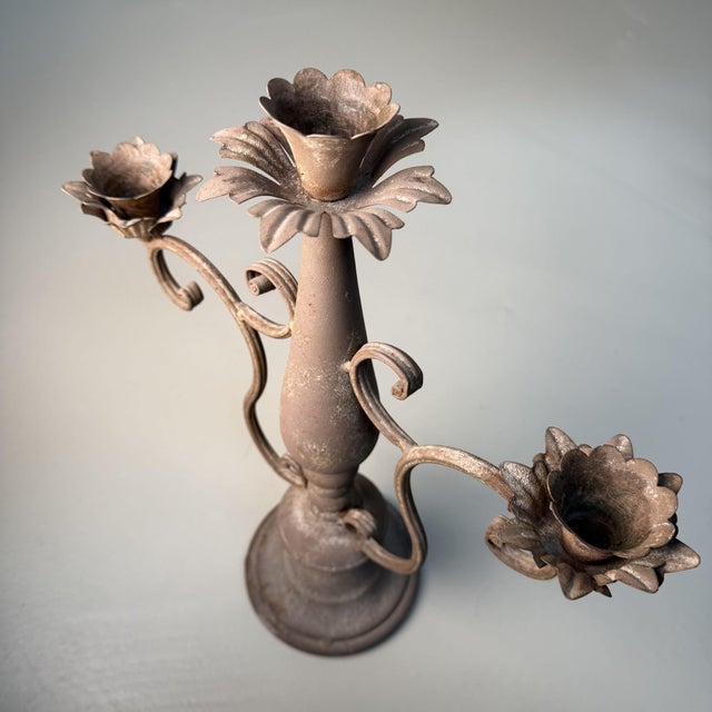 Elegant italian three-arm candelabrum featuring refined floral details and a beautifully aged patina. dimensions: h 42 × w...