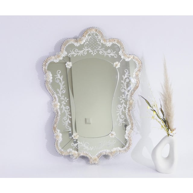 A vintage Venetian style mirror made in Italy with a beautiful scalloped silhouette, adorned with delicate etched floral...