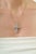 The Handcrafted Modern Style Natural 3.09 Ct Sky Blue Topaz & Sterling Silver Cross Pendant features a clean, geometric...