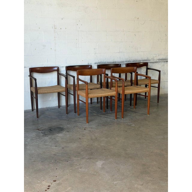 This set of six dining armchairs features a sculpted organic form with elegantly sweeping armrests. Their streamlined...