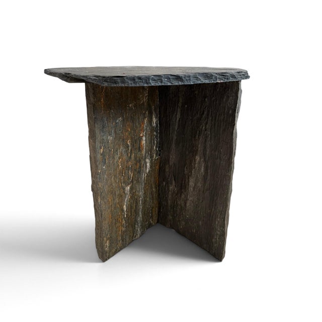 A French side table featuring a sculptural triangular slate top and an understated architectural silhouette. Crafted from...