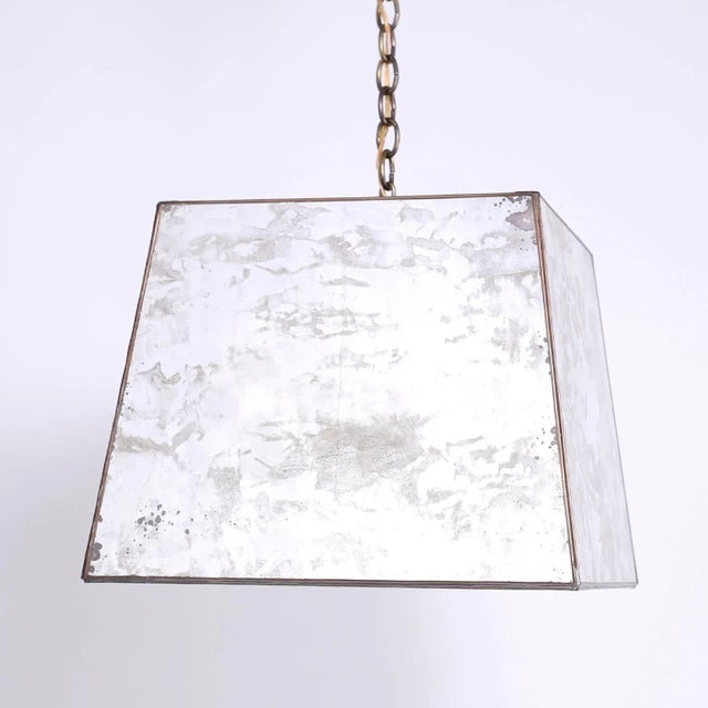 Unique midcentury pendant with marbleized and oxidized mirrored panels in a trapezoid form. The bottom has an open square...