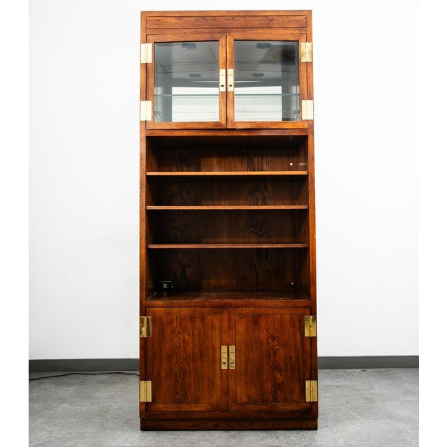 Campaign style storage cabinet by Henredon from the Scene One collection. Dark walnut with brass hinges and latch pulls....