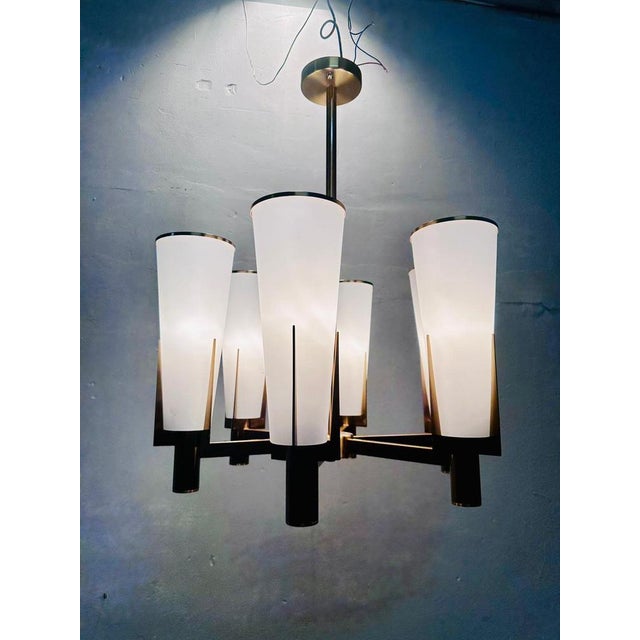 Refined vintage hanging chandelier dating from the 1940s, in perfect modernist style. The metal frame with brass finish...