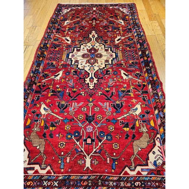"This vintage hand-knotted Persian Malayer gallery rug is a lively and rare find from the mid-1900s, celebrated for its...