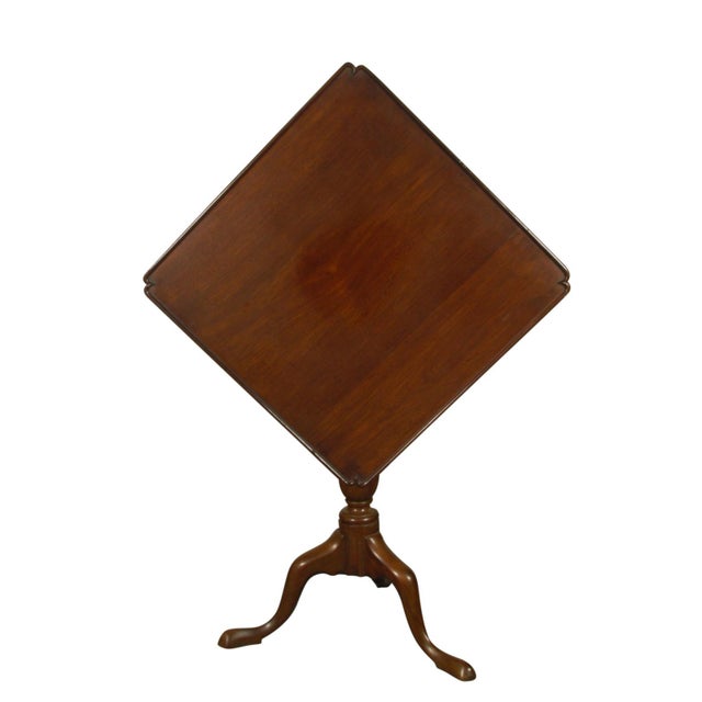 An early 19th-C. American tip-top mahogany tea table with bird-cage swivel mechanism and hand carved dish-top edge and base.