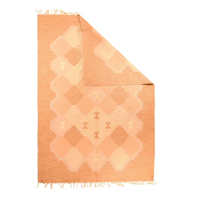 The tangerine rust "border" expands at the corners and frames a stepped lozenge tile pattern in straw, tangerine-rust and...