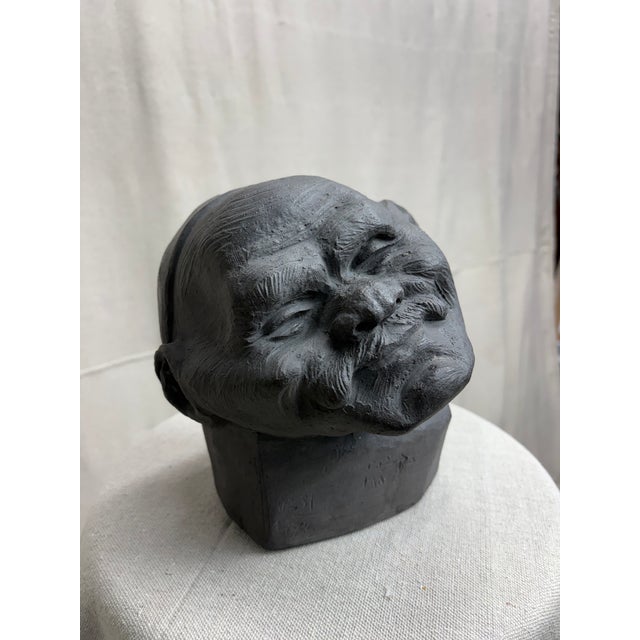 A deeply expressive clay head sculpture by Egyptian modernist Hassan Heshmat (1920–2006), titled Mister Ma’lesh and signed...