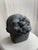 A deeply expressive clay head sculpture by Egyptian modernist Hassan Heshmat (1920–2006), titled Mister Ma’lesh and signed...