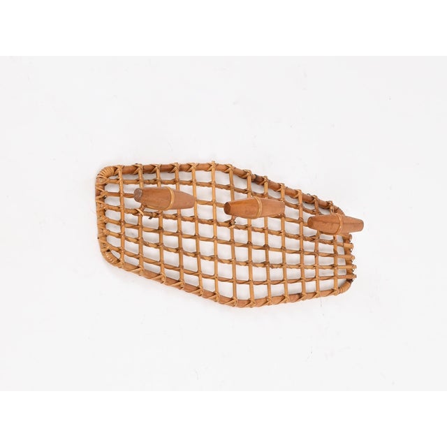 Wonderful and unique mid-century organic coat rack in bamboo, curved rattan, hand-woven wicker, and walnut wood. This...