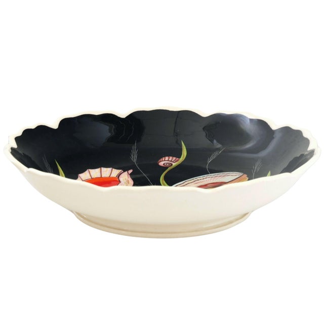 A scalloped Henriot Quimper serving bowl hand-painted by celebrated artist Guy Trévoux. Finished in the distinctive black...