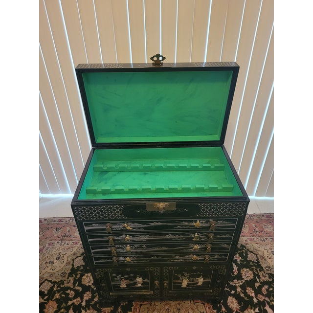 A beautifully crafted black‑lacquer silverware/flatware cabinet featuring hand‑painted detailing, mother‑of‑pearl figural...