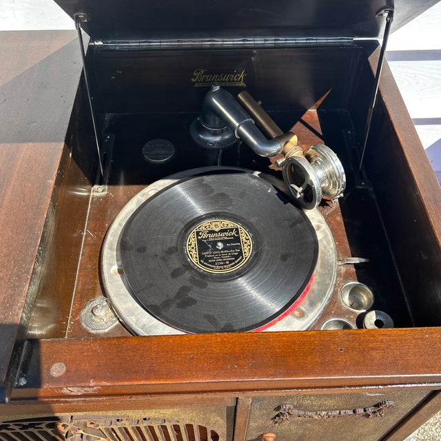 The Antique Brunswick Console Model Phonograph from the 1920s is a highly sought-after collectible item for music...