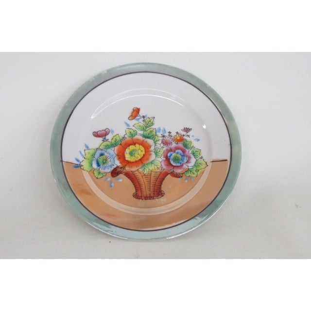 This darling Small Plate is made out of porcelain with lusterware glaze. This lovely plate is marked on the bottom as...