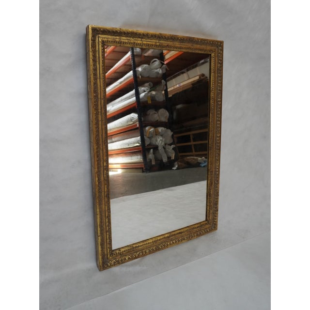 Beautiful, large carved mirror by MLA (Melissa Levinson). Neoclassical style with gold leaf detail. Produced to give an...
