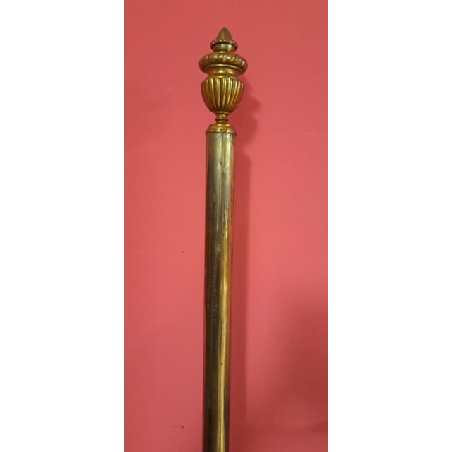 Italian-style brass headboard with a neoclassical design, adorned with scrolls and filigree details ending in leaves....