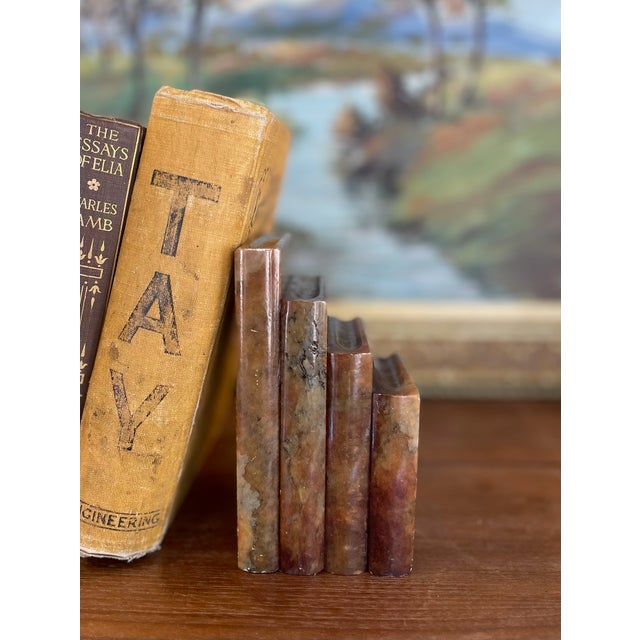 This unique vintage bookend is crafted from what is likely richly variegated onyx marble, featuring natural earth tones in...