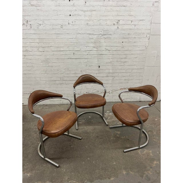 RETRO RETRO RETRO! These 1970’s vintage DAYSTROM postmodern cantilever chairs crafted from chrome and vinyl displays a...