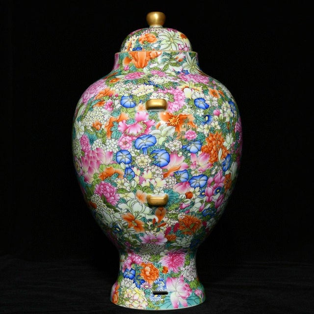 This striking vintage porcelain jar features a classic baluster form with a domed lid, adorned with four gilt lug handles...