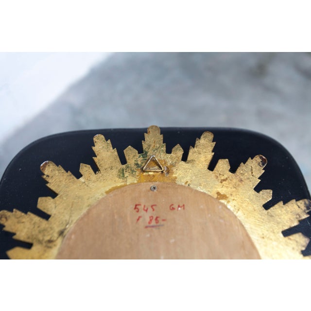 Vintage 1970s convex witch's eye sunburst mirror. It is in very good condition. Pleasant patina on the gilded wooden...