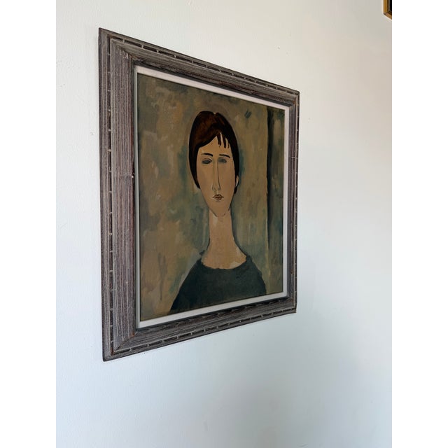 Vintage 1970s reproduction of a classic Amadeo Modigliani portrait, rendered in casein on masonite. The piece beautifully...