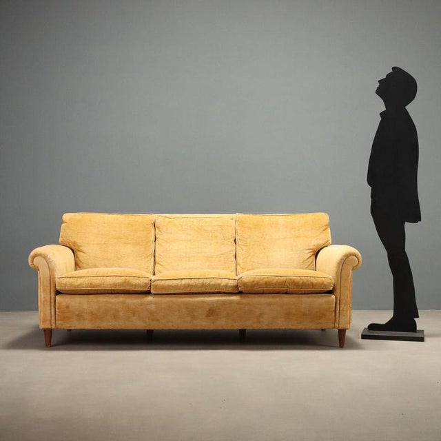 1950s three-seater sofa featuring a classic and timeless design, ideal for vintage enthusiasts. The solid structure is...