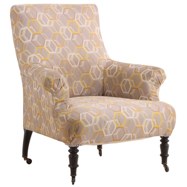 A handsome French Napoleon III library chair with a substantial, comfortably proportioned form, raised on turned ebonized...