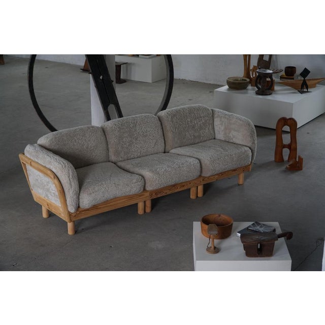 Beautiful Danish three-seater sofa crafted in solid pine, produced during the 1980s. The sofa features a robust pine frame...