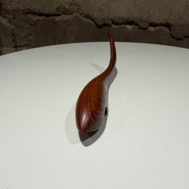For your consideration, a collectible vintage teak wood bottle opener shaped like a fish or shark, likely designed in...