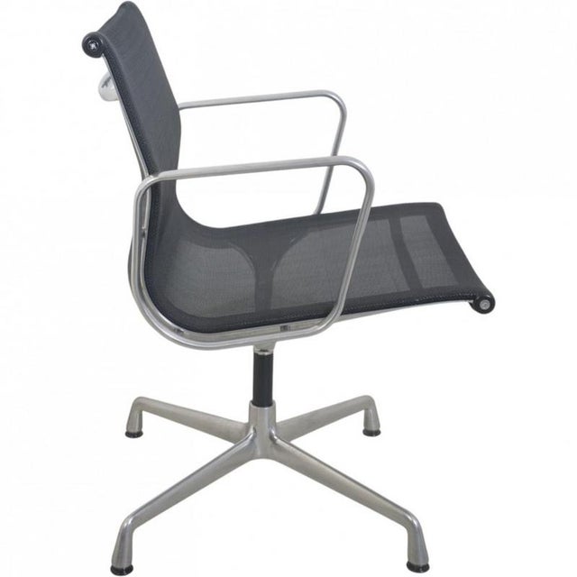 Charles Eames EA108 office chair upholstered in black mesh, and with an aluminium frame. The chair is from the 2000s and...