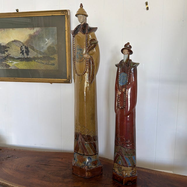 Striking pair of large-scale glazed ceramic figures modeled in the manner of traditional Chinese court officials or...