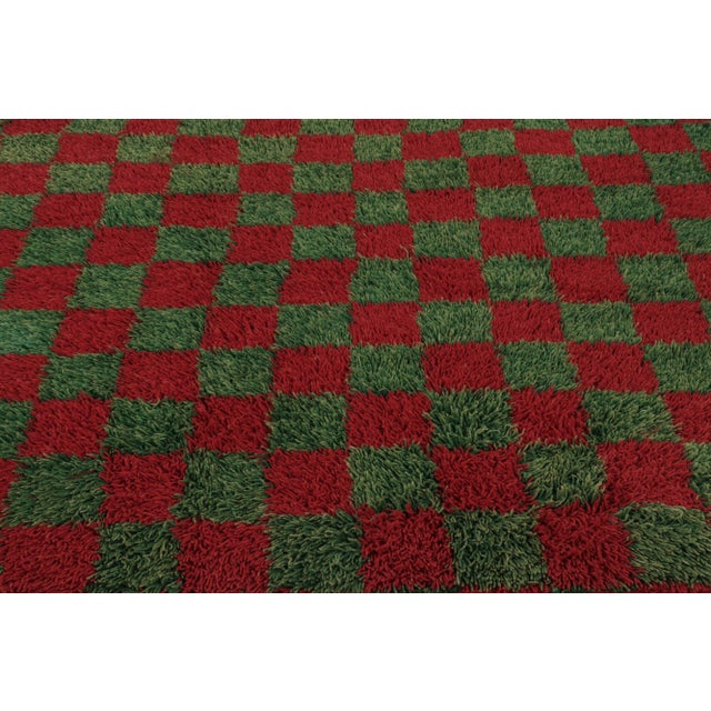 Made with hand-knotted high-pile wool in Turkey, this 5x7 vintage Tulu rug is a distinguished addition to Rug & Kilim’s...