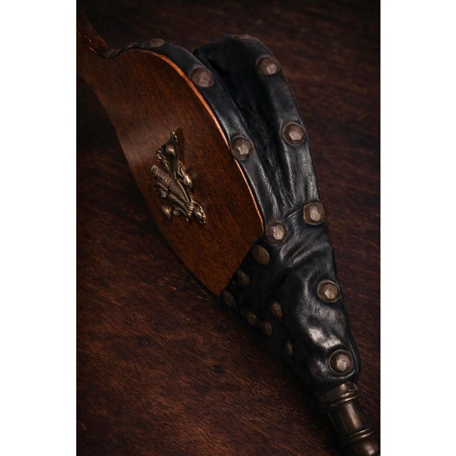 Made for use by the inglenook, this fireplace bellows dates to the 1890s and is constructed of wood and leather with age-...