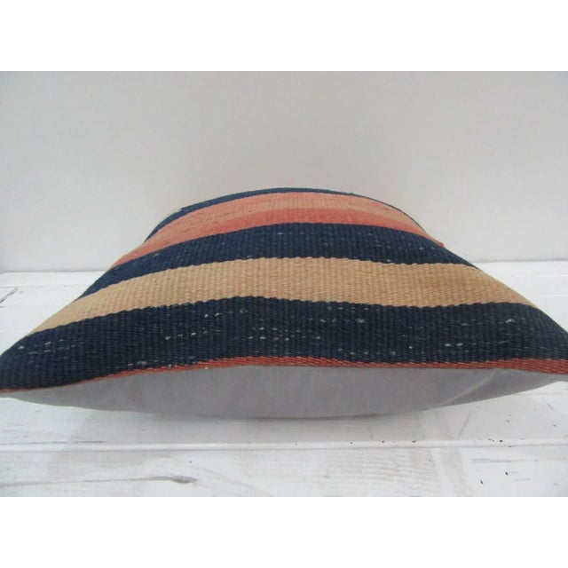 This is a pillow cover made from a vintage kilim rug. The piece was properly washed and ready to use. Pillow inserts not...