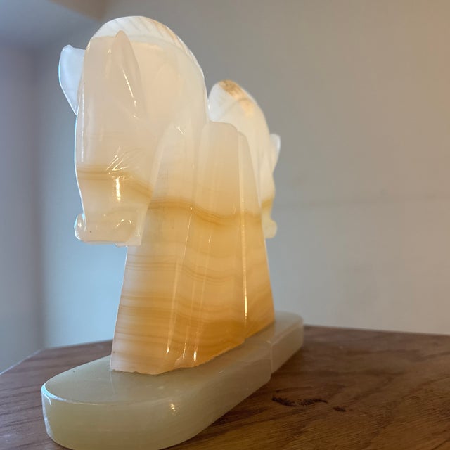 A striking pair of marble horse bookends, beautifully sculpted with strong equestrian form and timeless presence. Carved...