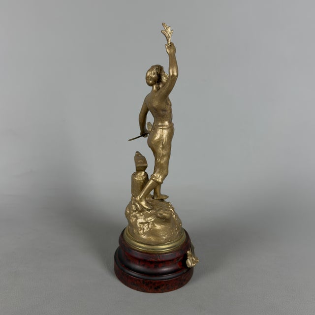 A splendid sculpture that pays homage to the noble art of blacksmithing and manual labor. This early 20th-century...