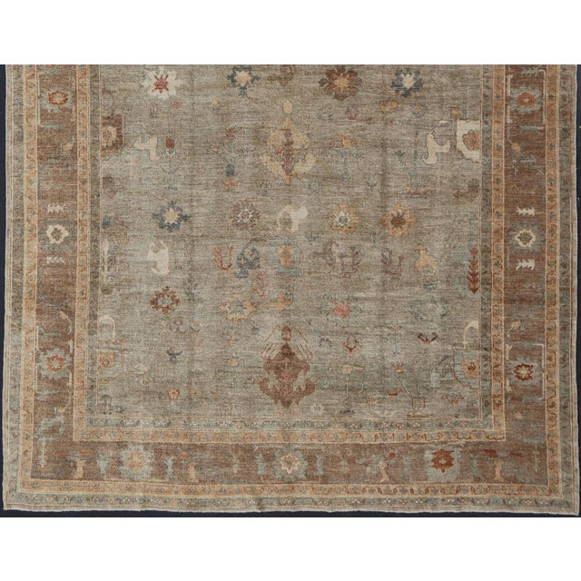 Measures: 11'10 x 17'4 Large Turkish Angora Oushak Rug in Washed Sage with Rust and Ivory 11'10 x 17'4. Keivan Woven Arts....