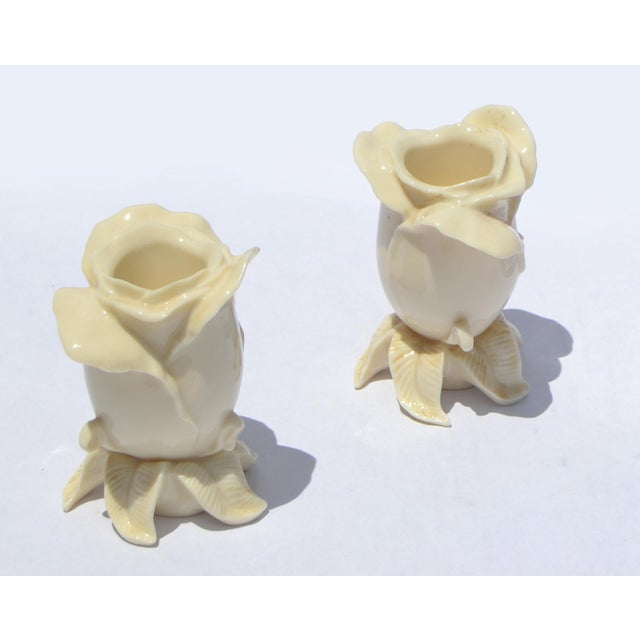 Charming Pair of Lenox rose-shaped candle holders are elegant porcelain pieces, crafted in beige-tan, featuring a delicate...