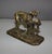 Bronze animal sculpture, "greyhound with hare," depicting a greyhound holding a hare in its mouth, signed in relief on the...
