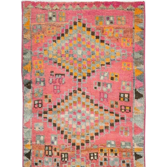 A vintage Turkish Oushak runner handmade during the mid-20th century with a tribal pattern in a bright and colorful...